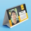 Custom printed calendar with company branding and vibrant monthly design.